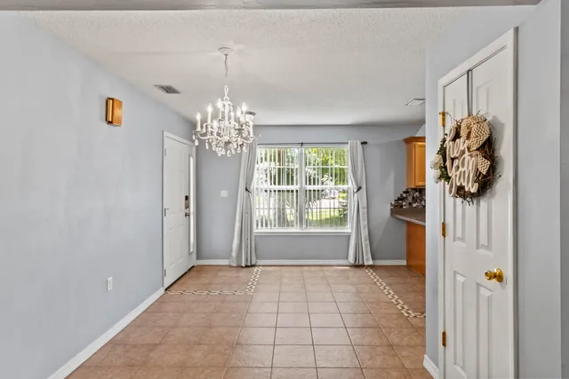 a view of a room with window and chandelier