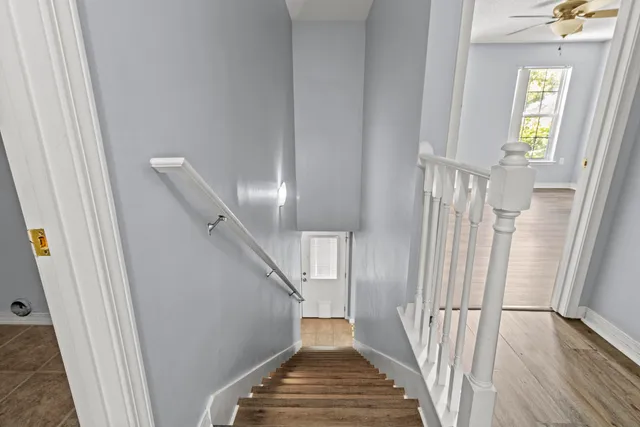 a view of a hallway with wooden floor