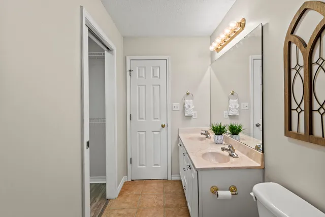 a bathroom with a sink a toilet and mirror