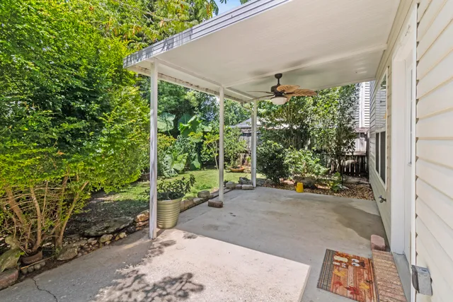 a view of a backyard with table and chairs and potted plants