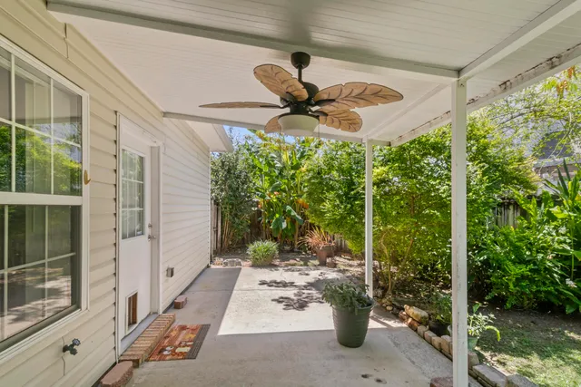 a view of a patio with table and chairs and potted plants