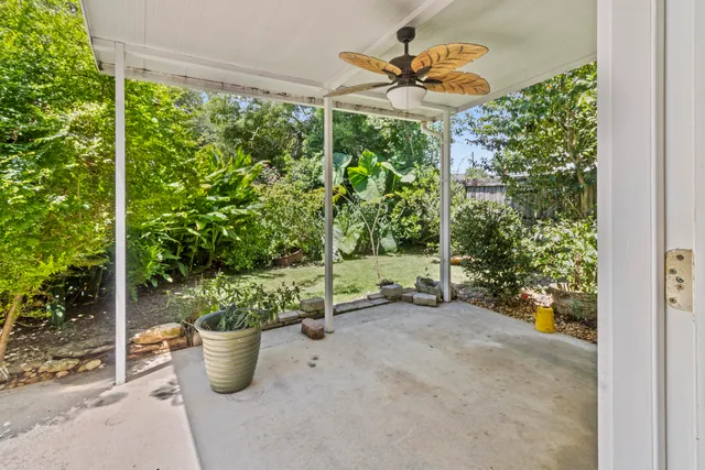 a view of a patio with table and chairs and potted plants