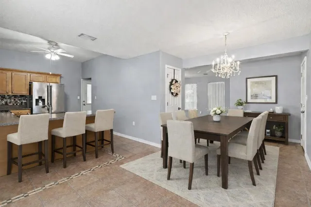 a view of a dining room with furniture and window