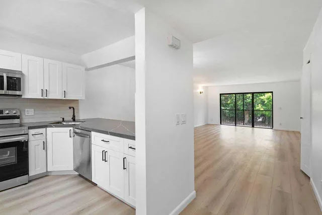 a kitchen with stainless steel appliances granite countertop a sink and stove top oven