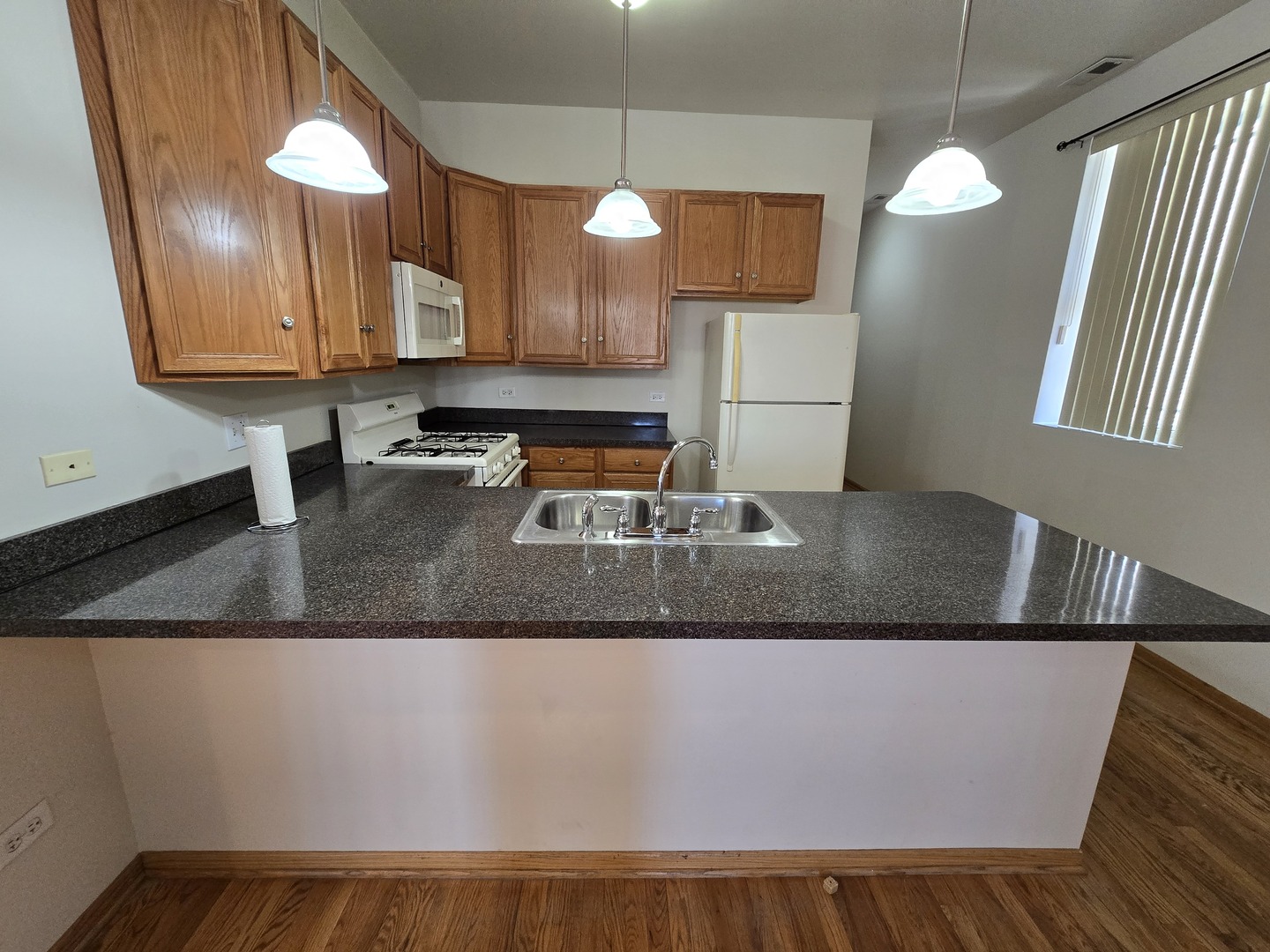 1700 West Cermak Road, Unit 2R Chicago, IL 60608 - Photo 2 of 10 a kitchen with a sink and a mirror