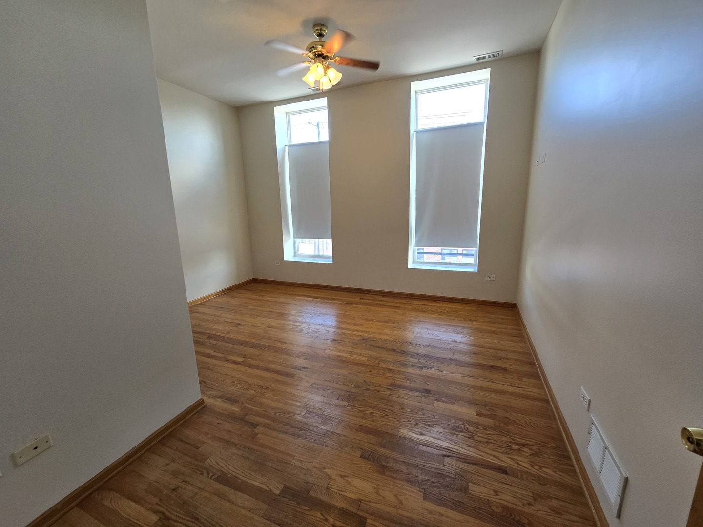 1700 West Cermak Road, Unit 2R Chicago, IL 60608 - Photo 4 of 10 an empty room with wooden floor and windows
