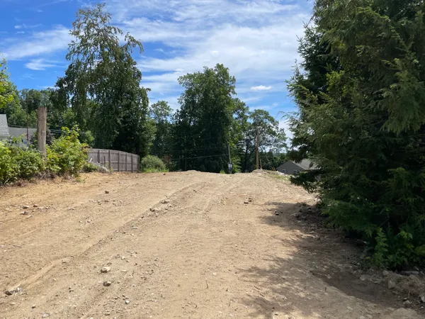 a view of wooden fence under a large tree
