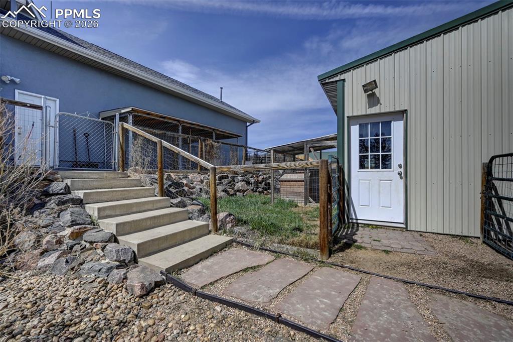 5910 McCart Ranch Circle Elizabeth, CO 80107 - Photo 30 of 50 a view of entryway with wooden walls and stairs