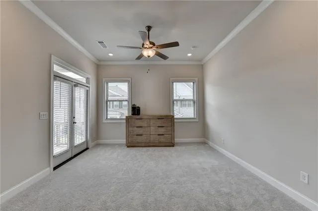 an empty room with closet and a ceiling fan
