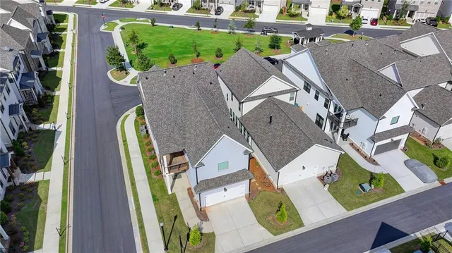 an aerial view of a house with a yard