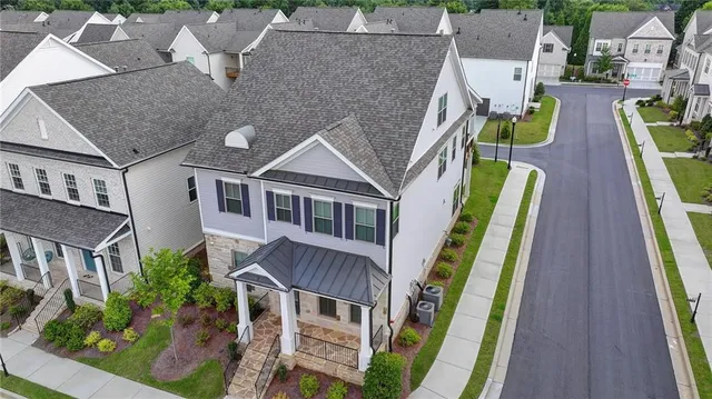 an aerial view of a house with an outdoor space
