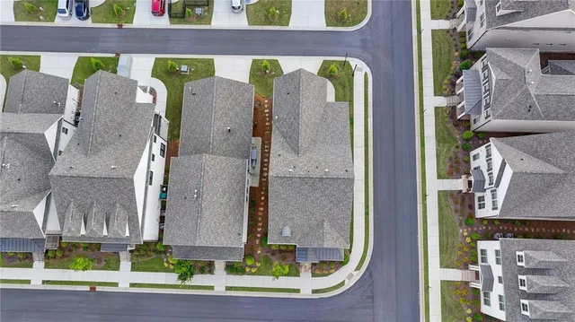an aerial view of a house with garden space and lake view