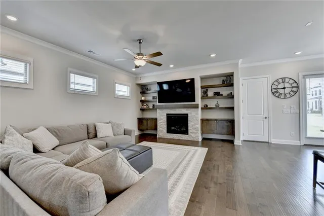 a living room with fireplace furniture and a flat screen tv