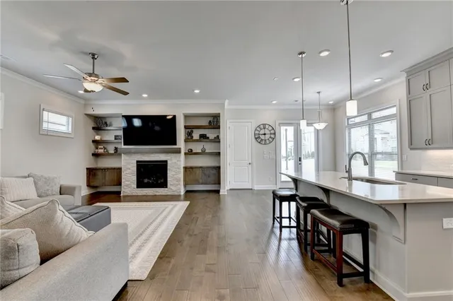 a living room with furniture a flat screen tv and a fireplace