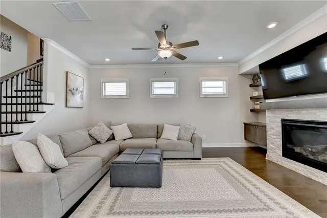 a living room with furniture and kitchen view
