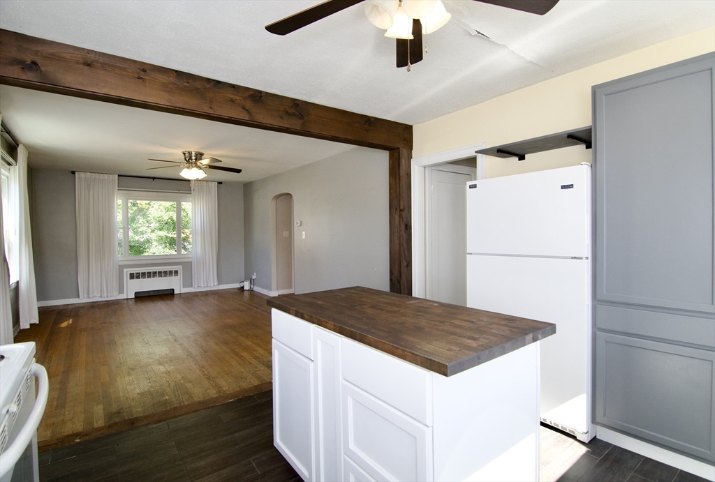 586 Granby Road South Hadley, MA 01075 - Photo 12 of 36 a kitchen with stainless steel appliances granite countertop a refrigerator a oven and white cabinets with wooden floors