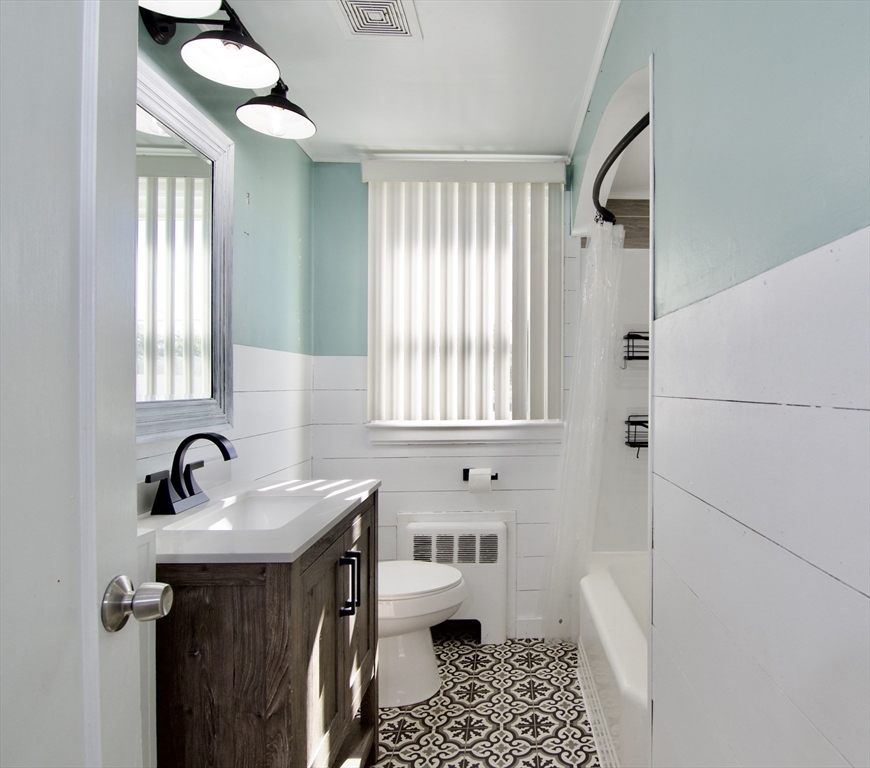 586 Granby Road South Hadley, MA 01075 - Photo 13 of 36 a bathroom with a sink a toilet and a window