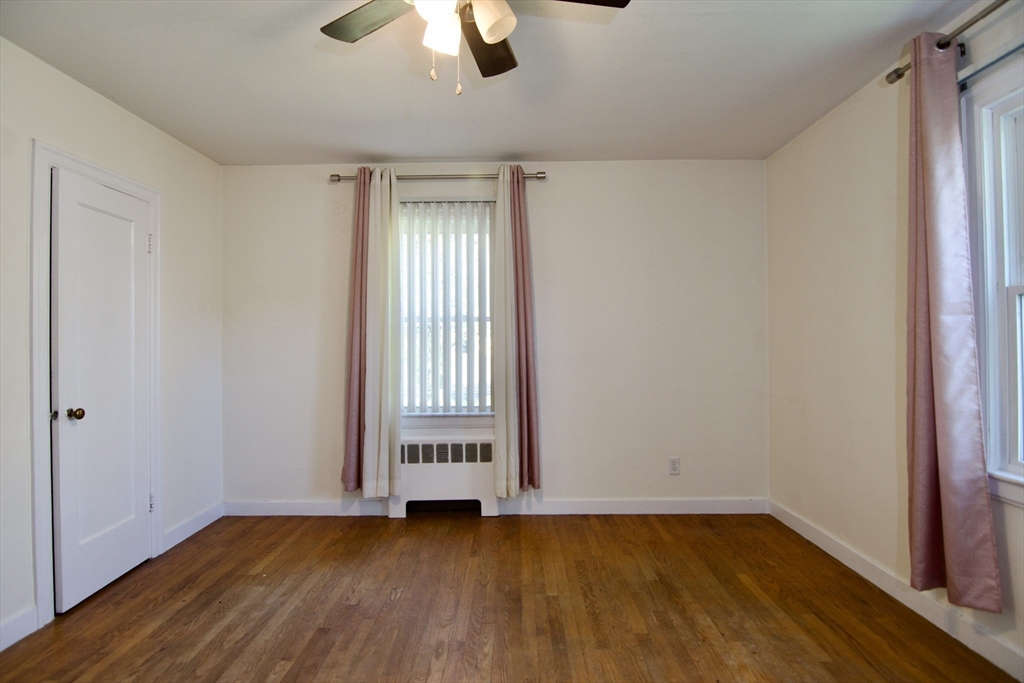586 Granby Road South Hadley, MA 01075 - Photo 21 of 36 an empty room with wooden floor cabinet and windows