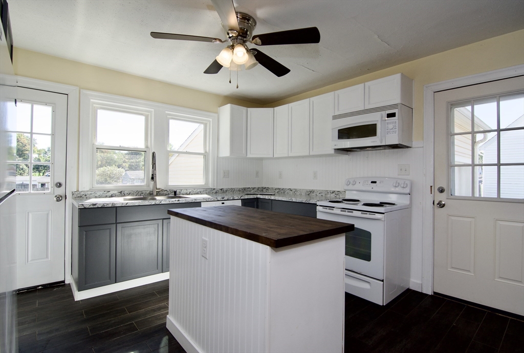 586 Granby Road South Hadley, MA 01075 - Photo 9 of 36 a kitchen with a stove a sink and a microwave