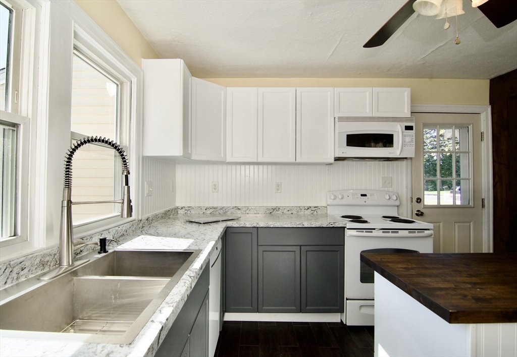 586 Granby Road South Hadley, MA 01075 - Photo 10 of 36 a kitchen with granite countertop a sink a stove and cabinets