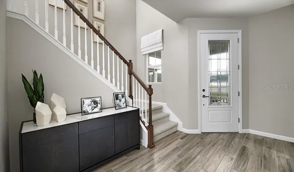 a view of entryway and hall with wooden floor