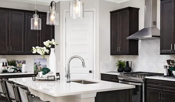 a kitchen with a sink refrigerator and cabinets