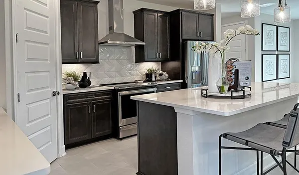 a kitchen with stainless steel appliances granite countertop a stove and a refrigerator