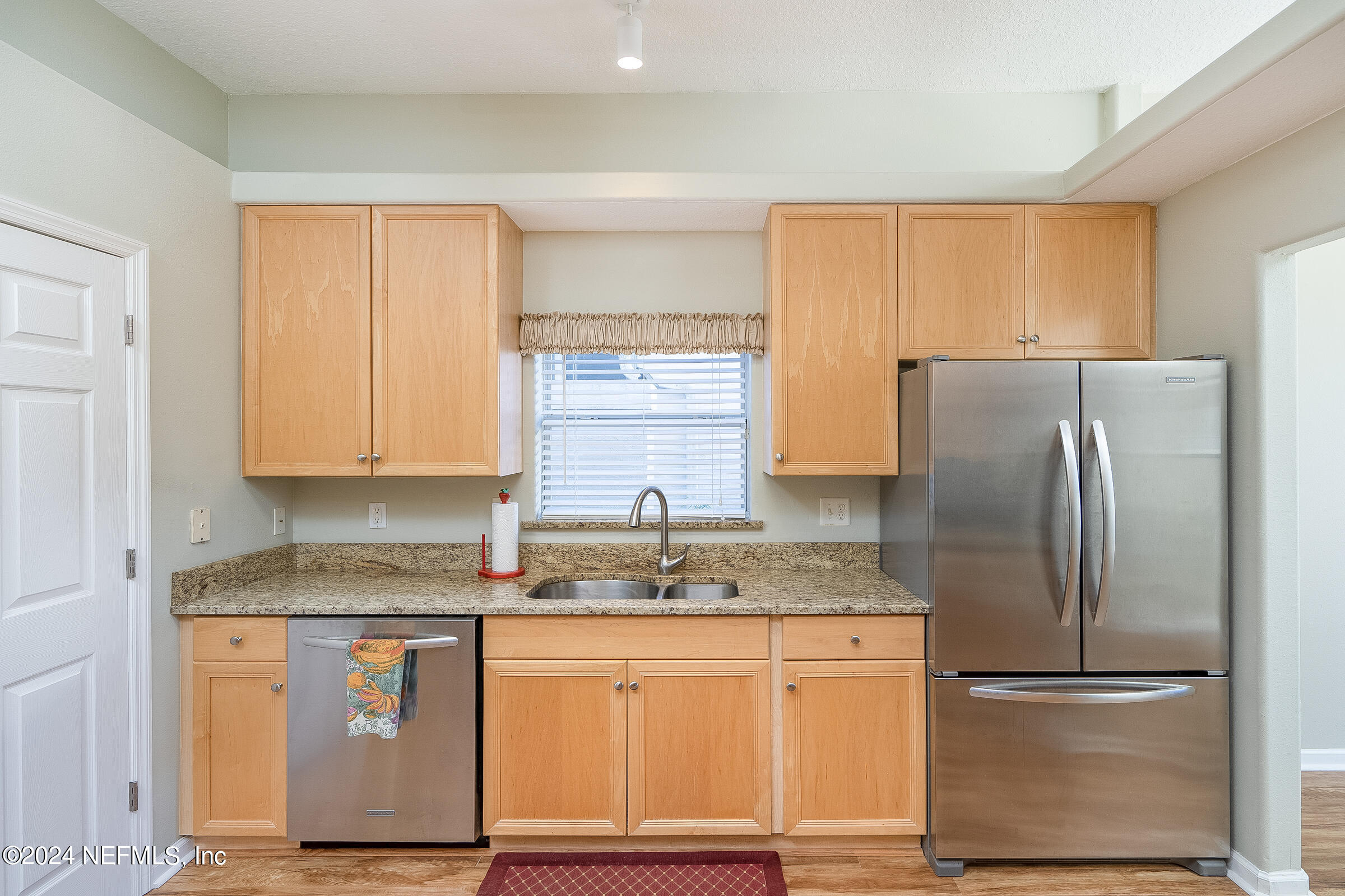 165 Cedar Ridge Circle St. Augustine, FL 32080 - Photo 14 of 45 a kitchen with granite countertop stainless steel appliances and refrigerator