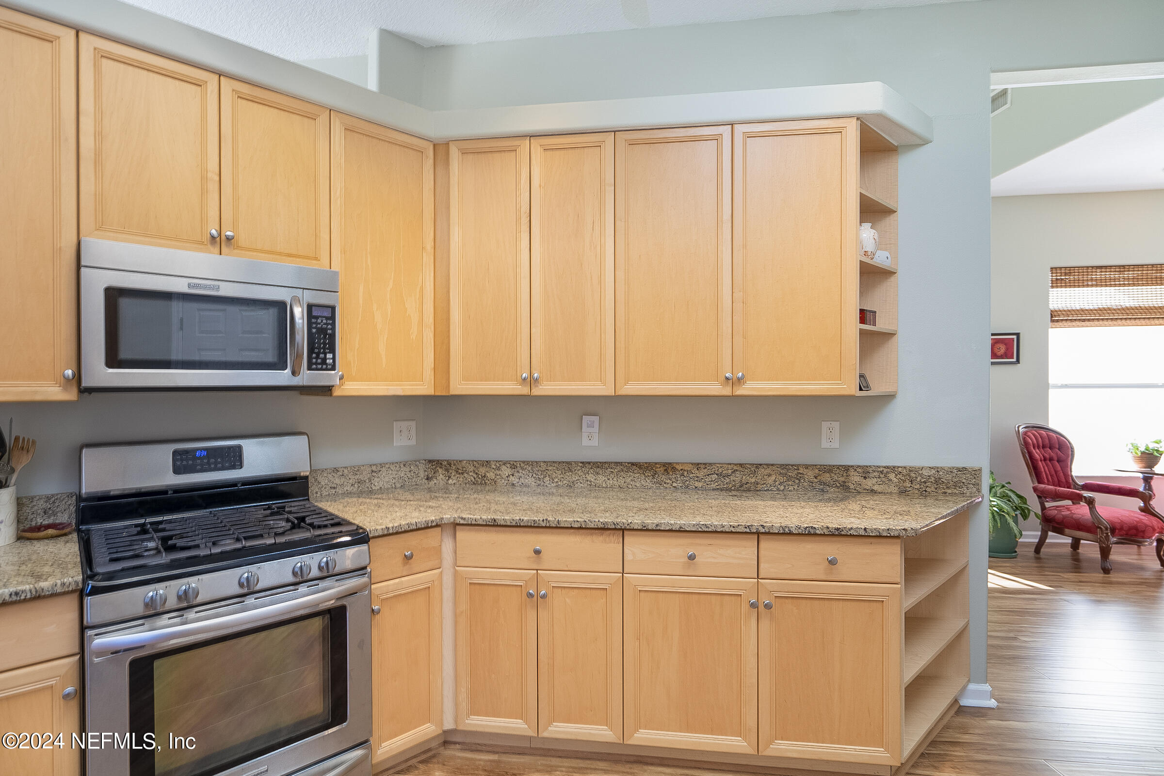 165 Cedar Ridge Circle St. Augustine, FL 32080 - Photo 16 of 45 a kitchen with granite countertop cabinets stainless steel appliances and wooden floor