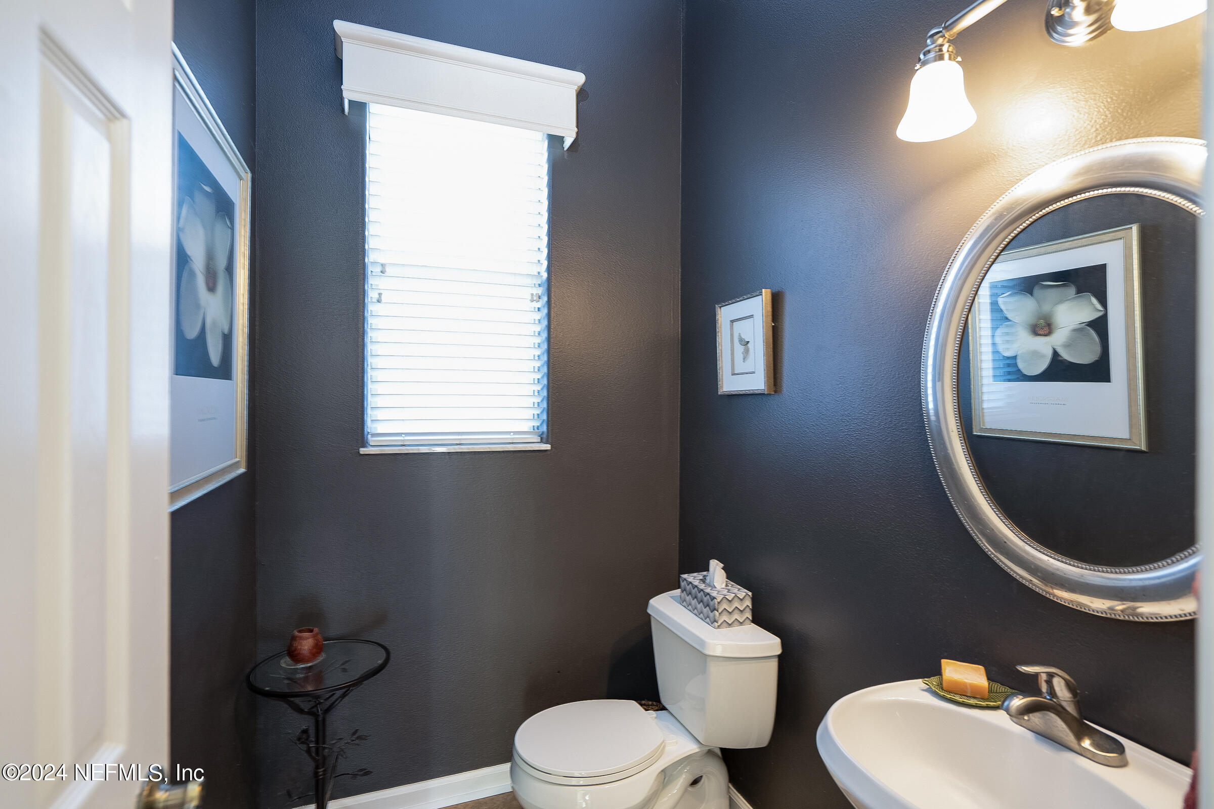 165 Cedar Ridge Circle St. Augustine, FL 32080 - Photo 17 of 45 a bathroom with a toilet a sink and mirror