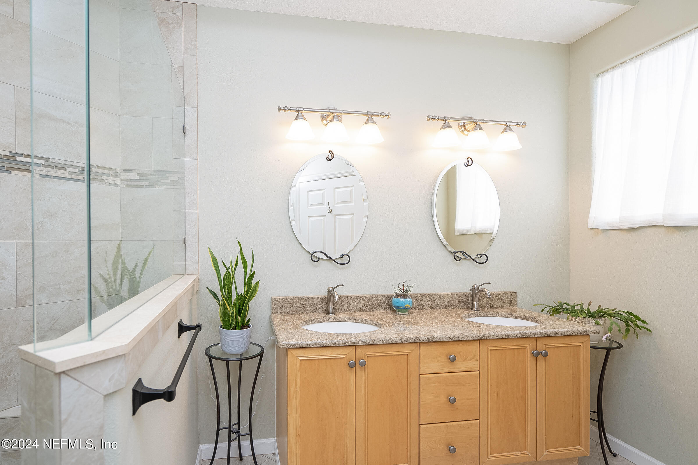 165 Cedar Ridge Circle St. Augustine, FL 32080 - Photo 23 of 45 a bathroom with a granite countertop sink a mirror and a potted plant