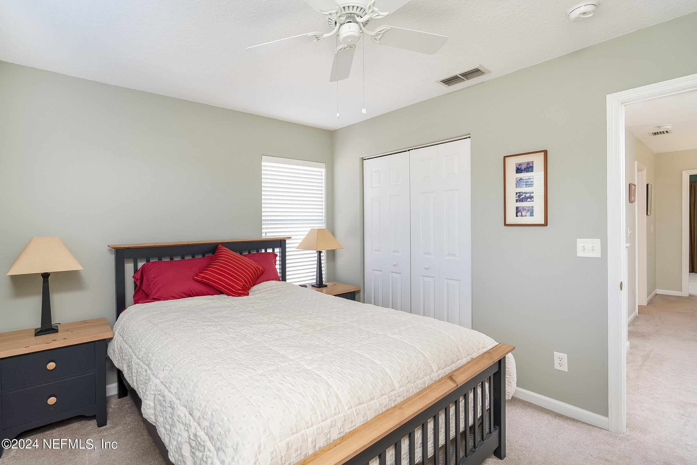 165 Cedar Ridge Circle St. Augustine, FL 32080 - Photo 27 of 45 a bedroom with a large bed and a chandelier