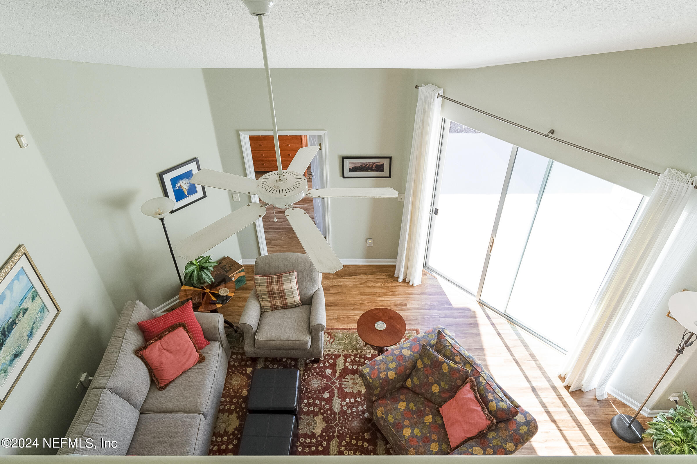 165 Cedar Ridge Circle St. Augustine, FL 32080 - Photo 36 of 45 a living room with furniture and a floor to ceiling window