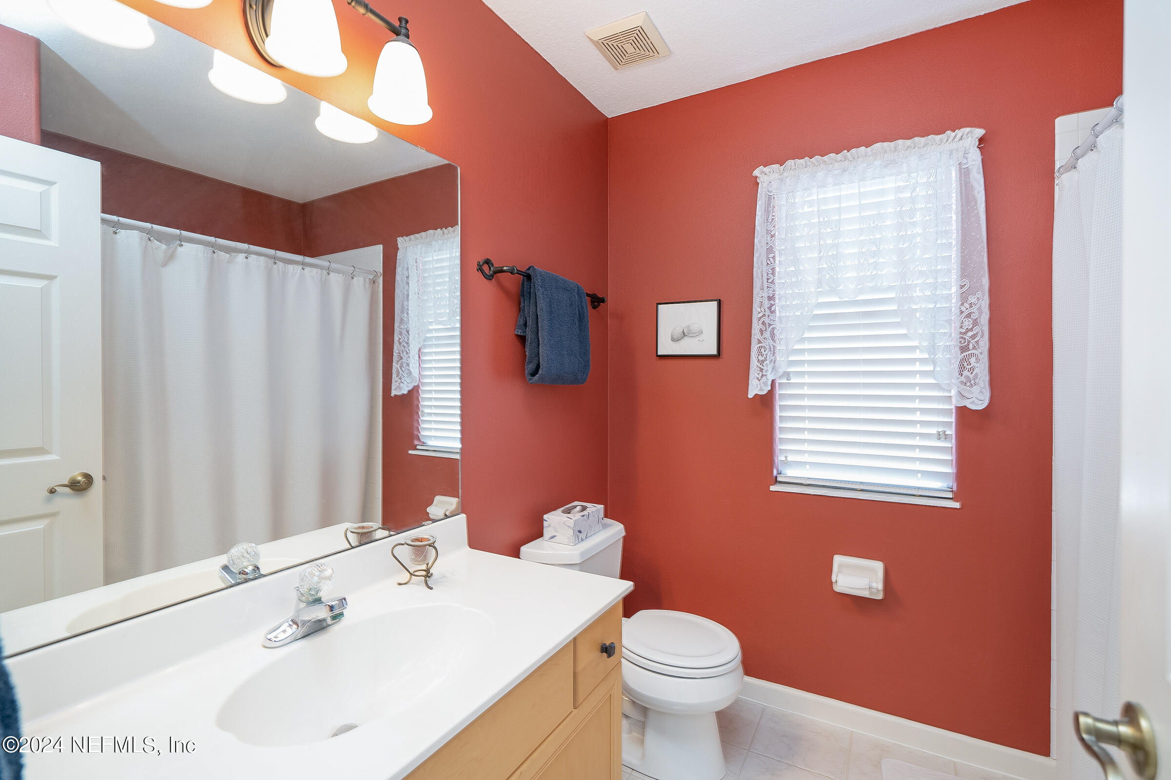 165 Cedar Ridge Circle St. Augustine, FL 32080 - Photo 38 of 45 a bathroom with a sink a toilet and a mirror