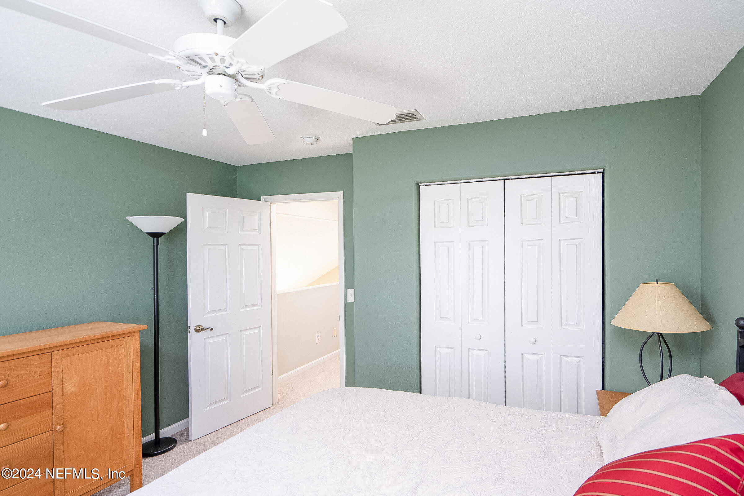 165 Cedar Ridge Circle St. Augustine, FL 32080 - Photo 39 of 45 a bedroom with a bed and a ceiling fan