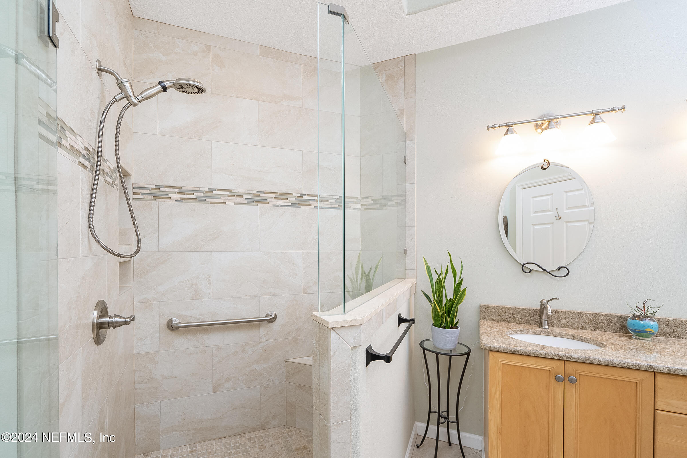 165 Cedar Ridge Circle St. Augustine, FL 32080 - Photo 4 of 45 a bathroom with a granite countertop sink a mirror and a shower