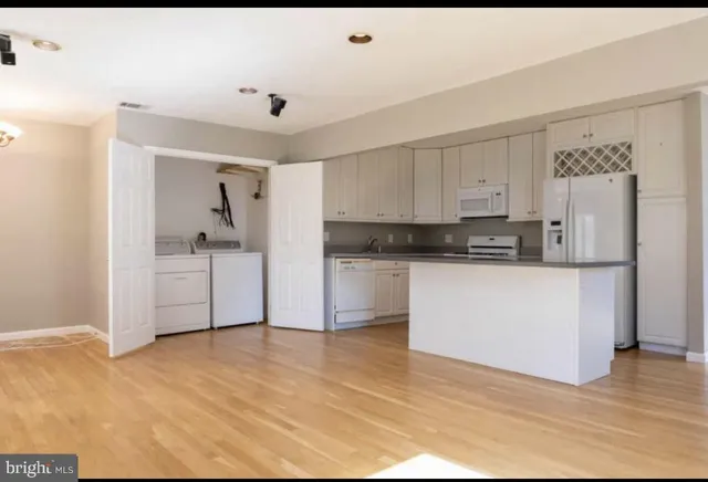 a kitchen with stainless steel appliances a refrigerator sink and cabinets