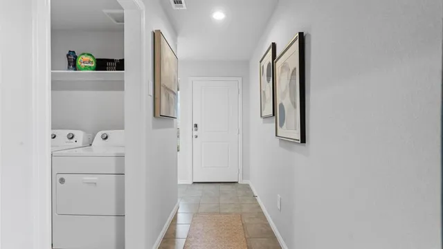 a view of a hallway with wooden floor and dining room