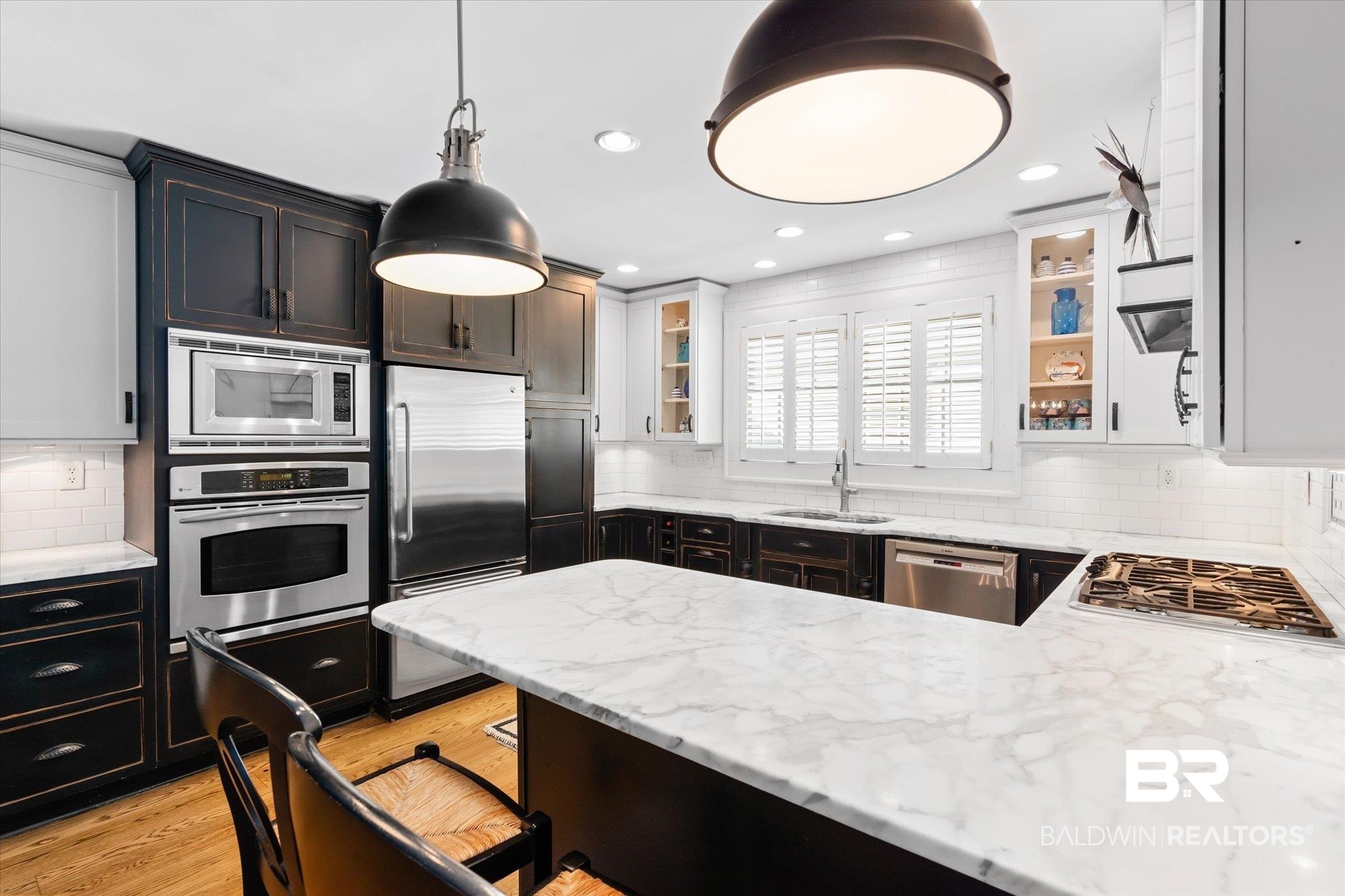 202 Woodlands Avenue Mobile, AL 36607 - Photo 11 of 53 Kitchen with tasteful backsplash, appliances with stainless steel finishes, light wood-type flooring, sink, and decorative light fixtures