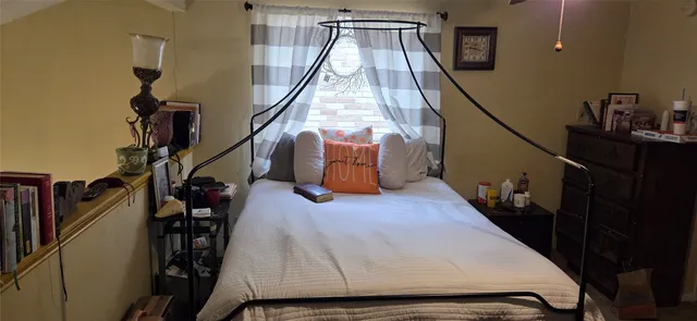 a bed sitting in a bedroom next to a window
