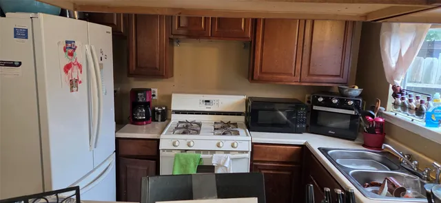 a kitchen with stainless steel appliances granite countertop a stove and a refrigerator