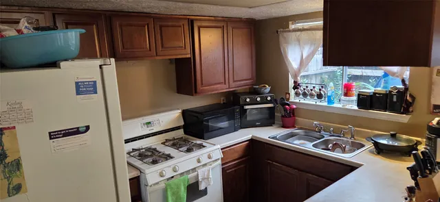 a kitchen with a refrigerator and a stove top oven