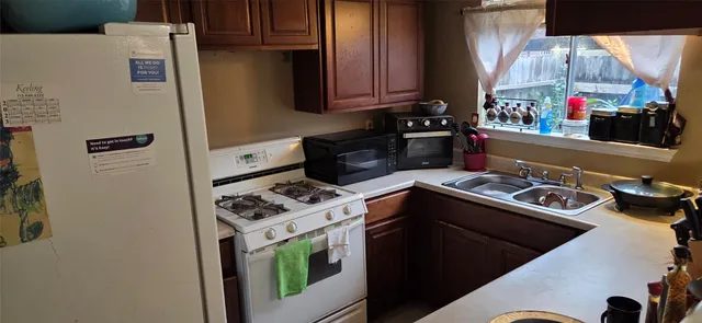 a kitchen with a stove and a refrigerator