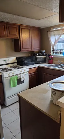 a kitchen with a stove a sink and a microwave