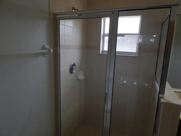 a bathroom with a glass shower door