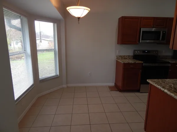 a kitchen with a stove top oven and cabinets