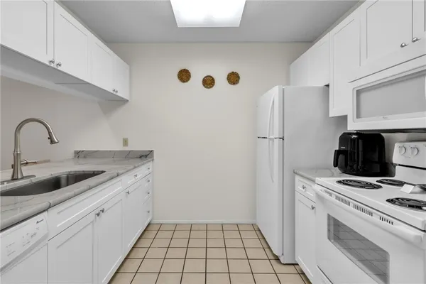 a kitchen with a sink cabinets and appliances