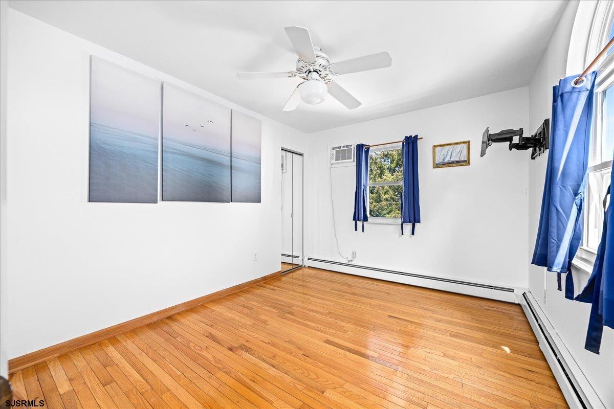 211 2nd Street South, Unit 2 Brigantine, NJ 08203 - Photo 16 of 35 a view of an empty room with wooden floor