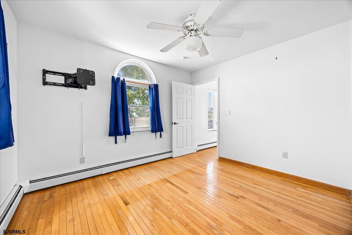 211 2nd Street South, Unit 2 Brigantine, NJ 08203 - Photo 17 of 35 a view of an empty room with window and wooden floor