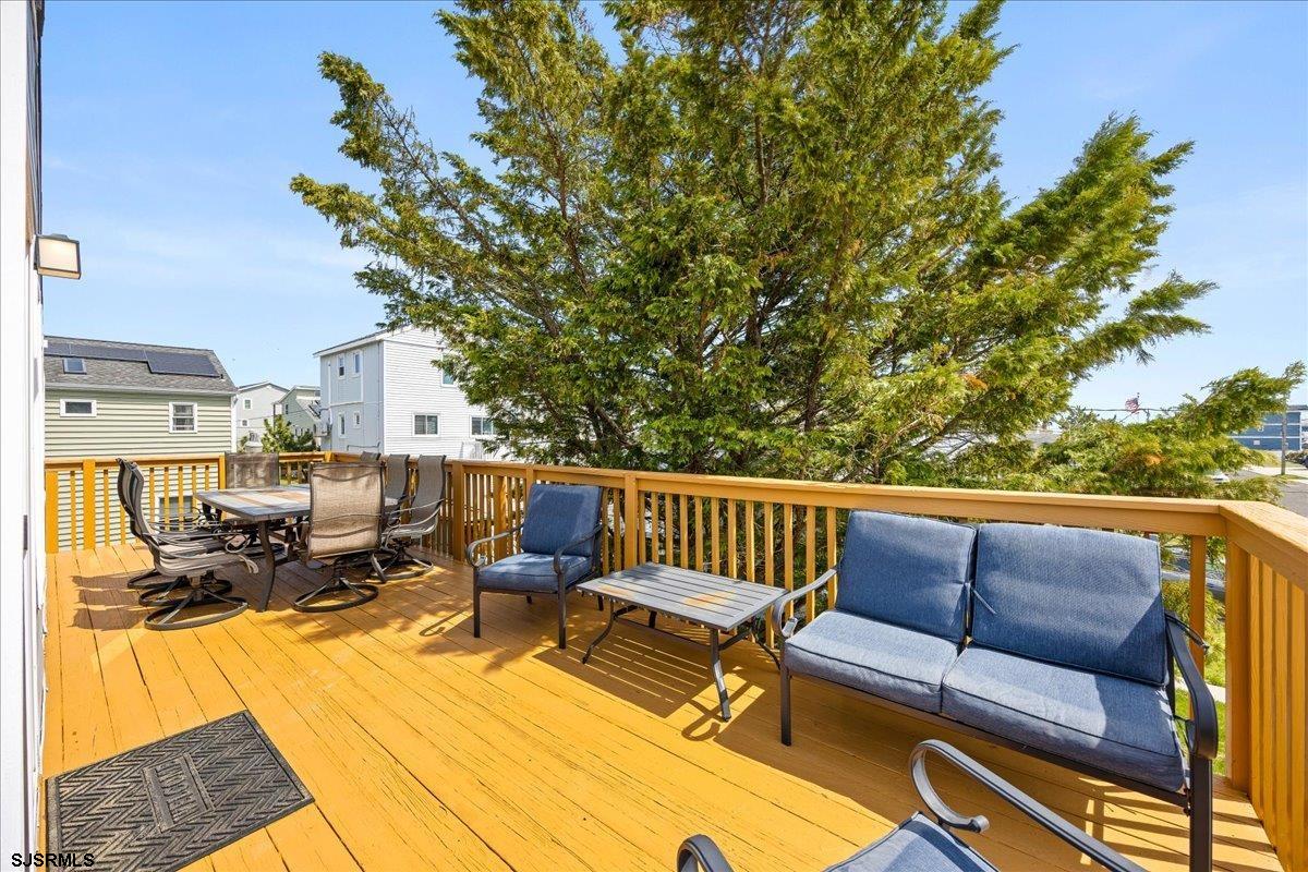 211 2nd Street South, Unit 2 Brigantine, NJ 08203 - Photo 21 of 35 a roof deck with couches and wooden floor